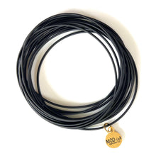 Load image into Gallery viewer, Black stackable spring bracelets set on wrist