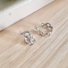 Load image into Gallery viewer, Small silver hoop earrings with an X design are dainty and perfect for every day wear