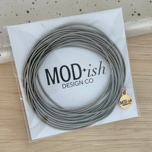 Load image into Gallery viewer, Waterproof steel coil bracelets stacked on wrist