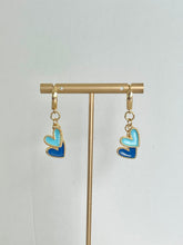 Load image into Gallery viewer, gold plated huggie hoop earrings with a royal blue and light blue enamel heart charms are perfect for Kansas City Royals games or as a gift