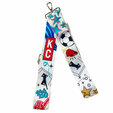 Load image into Gallery viewer, Adjustable bag strap with a collage of soccer themed graphics in support of the Kansas City Current women's team