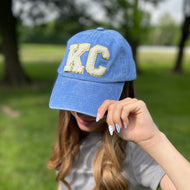 Vintage wash style blue baseball cap perfect for Royals games with chenille varsity KC lettering and adjustable back