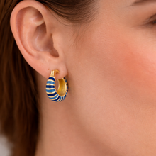 Load image into Gallery viewer, Woman wearing a gold hoop earring with blue enamel stripes.

