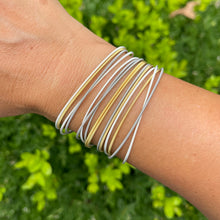 Load image into Gallery viewer, Gold and silver coil bracelet stack on wrist
