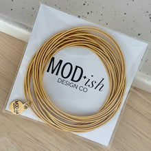 Load image into Gallery viewer, Gold coil bracelets stacked minimalist everyday style
