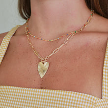 Load image into Gallery viewer, Gold heart necklace worn layered with other chains
