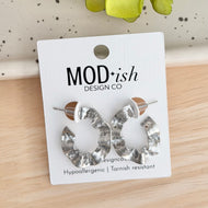 Silver tone, rhodium plated, wavy ruffle design oval hoop earrings