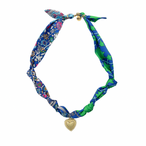 Colorful patterned neck scarf with a gold heart pendant on a white background