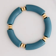 Muted turquoise acrylic tube beads separated by textured gold-plated rondelle beads sourced from India create a gorgous bracelet that adds a pop of color to your stack