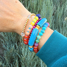 Load image into Gallery viewer, Bracelet stack featuring gold plated beads, colorful gemstone beads in jewel-tones and a chunky acrylic tube bead bracelet.  Various textures and colors add interest to your arm party!
