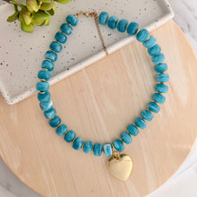 Load image into Gallery viewer, Chunky teal resin beaded necklace is perfect to add a pop of color to your fall outfit.  Gold heart charm is removable allowing 2 different looks
