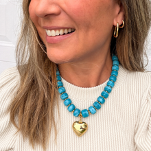 Load image into Gallery viewer, Chunky teal blue necklace is perfect to add a pop of color to your fall outfit.  The gold heart charm is removable allowing 2 different looks
