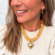 Load image into Gallery viewer, Chunky mustard yellow beaded necklace is perfect to add a pop of color to your fall outfit.  The gold heart charm is removable allowing 2 different looks
