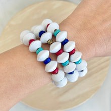 Load image into Gallery viewer, Patriotic bracelet stacked with other bracelets on wrist
