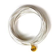 Silver stackable spring bracelets set on wrist