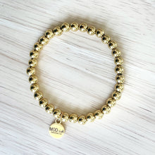 Load image into Gallery viewer, 18k gold plated beads on a durable stretch cord creates a comfortable bracelet that is perfect for stacking
