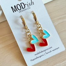 Load image into Gallery viewer, gold plated huggie hoop earrings with a red and teal enamel heart charm are perfect for Kansas City women's soccer games to support the KC Current
